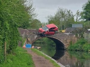 Supporting image for story: Two taken to hospital after car left dangling off canal bridge as investigation continues