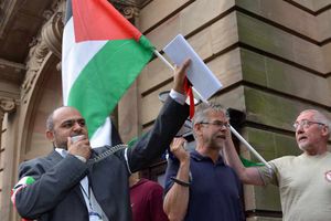 Cllr Aftab Nawaz addresses members of the Walsall Coalition for Palastinian Rights protesting outside the meeting.