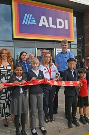  Megan Richter cuts the ribbon on the brand new Aldi with with store manager Liam Jones in the background