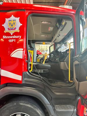 Firefighter Barbie at the wheel of one of Shrewsbury's big red fire trucks