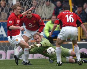 Wolves keeper Michael Oakes is surrounded.