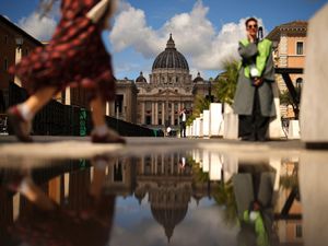 People walk in St Peter's Square