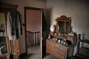 A bedroom, with a hanging jacket