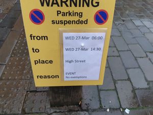 Parking enforcement signs near the Square