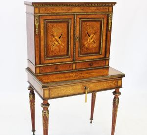 A Louis XVI style burr yew and walnut bonheur du jour which took £2,000