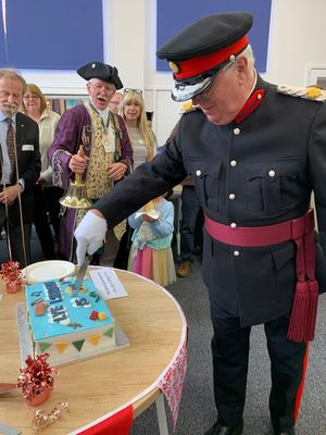 Deputy Lord Lieutenant Nick Venning cuts the Lye Library birthday cake