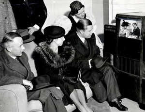 A group watching an early television at the 1937 Ideal Home Exhibition at Olympia.