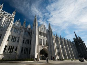 Exterior view of Marischal College in Aberdeen, under blue skies