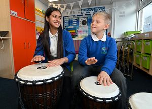 Jenika Arorra and Alex Batchelor, both aged 10, enjoy the drumming session