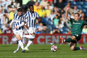 George Saville of Millwall blocks a shot from Mikey Johnston (Photo by Adam Fradgley/West Bromwich Albion FC via Getty Images).
