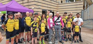 Hugh Porter and Anita Lonsbrough are greeted by members of Wolverhampton Wheelers as they prepare to receive the baton