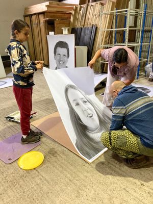 Pasting the portraits ready for the exhibition