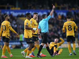 Michael Oliver shows a red card to Myles Lewis-Skelly of Arsenal (not pictured) after he fouled Matt Doherty of Wolverhampton Wanderer(Photo by Shaun Botterill/Getty Images)
