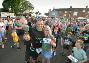 Andy Stone, at the end of his 70th triathlon, with his partner Sally Fenton.