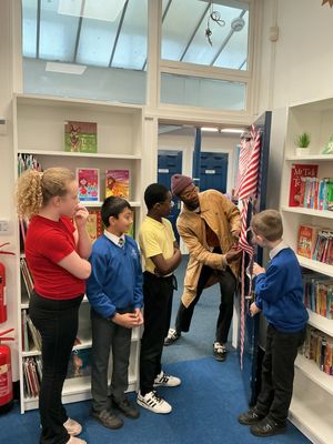 Actor Omari Douglas, second left, officially opens the new library at Claregate Primary School with pupils