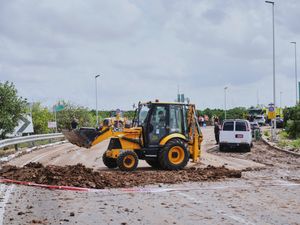 Israeli security forces clear debris from the road