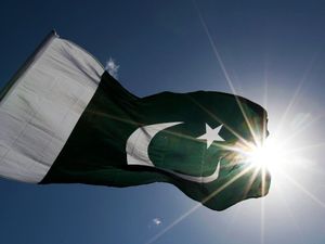 General view of Pakistan flag against the sun.