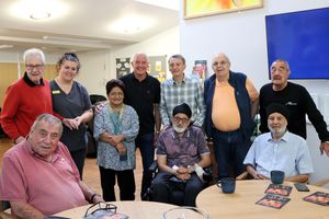 Steve Bull poses with Faye Simmonds and members of Compton Care's Living Well Centre during his visit