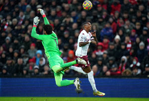 Liverpool goalkeeper Alisson (left) and Aston Villa's Ashley Young