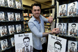 Ray signs copy of his book, This Time Round