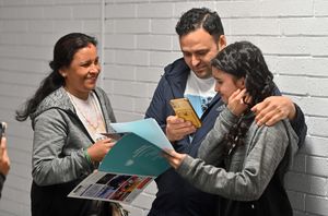 Devi Khanal takes in the enormity of her nine nines with her mother Nirmala and father Bhupraj