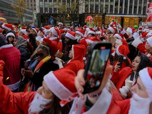 Supporting image for story: Santas and Grinches hit the streets for annual SantaCon bar crawls
