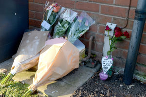 Flowers outside the house where Lynn McNally died