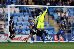 Marko Marosi of Shrewsbury Town saves this header from Sam Hughes of Burton Albion (AMA)