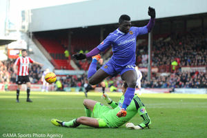 Brentford goalkeeper David Button beats Wolves' Bakary Sako to the ball