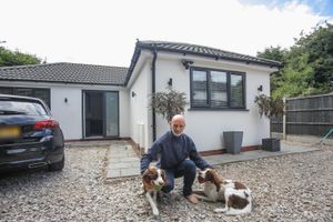 Mark Jones with his two dogs at their bungalow in Sutton Coldfield, West Midlands.