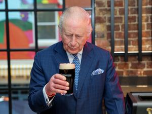 Supporting image for story: Charles plays barman and pulls the ‘perfect’ pint of Guinness
