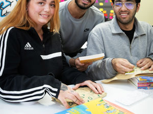 Supporting image for story: Amazon team packs books to donate to families and children in need