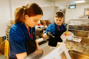 Kasey-Mae Thomas and Luca Walker working in catering