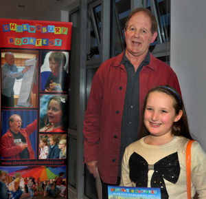 Letter-writing winner Lucy McGuire, from Moreton Hall First School, with Michael Morpurgo