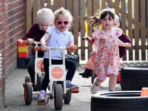 Nursery children enjoying one of the school's outdoor spaces