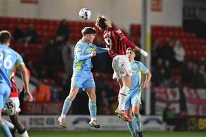 Walsall striker Aaron Pressley challenges for the ball against Fleetwood defender Conor Haughey.