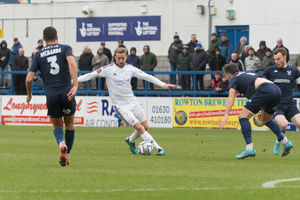 Carl Baker being pressured by Kidderminster Harriers players (Kieran Griffin)