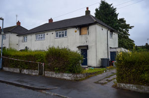 The upstairs window of the property was boarded up on Friday morning, after a man lost his life in the fire the night before. Photo: SnapperSK