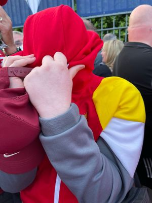 Mickey's son Declan covers his face to avoid the effect of pepper spray