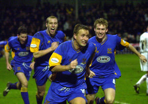 Peter Wilding, Dave Artell and Jamie Tolley chase goalscorer Nigel Jemson after he got the winner against Everton