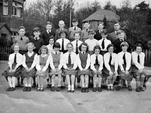 A slip of paper attached to this photo said: 'Cheswardine County Primary School, top class, circa 1960 to 1961. All the children lived in or within 2.3 mile radius, most in the parish.' It then gave following names (written here as originally spelt, reading from left): (back) Roger Beeston, Ken Lainton, John Ball, Richard Lunt, Robert Madders, Mr Thomas, headmaster. Middle: Paul Wright, Bryan Loynton, Elizabeth Nagginton, Pauline Humes, Sylvia Foster, Elizabeth Healy, Jennifer Parsons, Ian Forrester. Front: Annette Taylor, Dot Wassal, Pat Hoole, Jean Simpson, Pauline Baggott, Sara Madders, Angela Griffiths, Linda Parsons, Audrey Lea, me, Georgina Cooper, Gina Llewellyn. The 'me' i.e. the person who must have loaned the picture seems to be Georgina Cooper. 