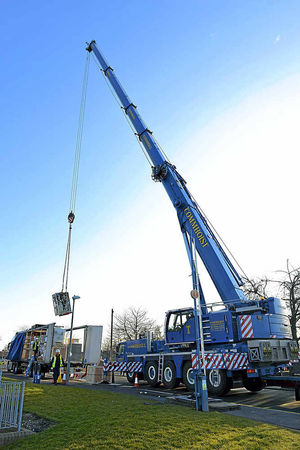 The new machine is lifted off the lorry by a giant crane