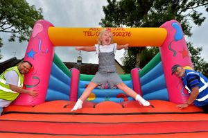 Honey Howell, age six, from Hednesford, enjoys the bouncy castle at the market – with market organisers Stuart Crabtree and Robin Kingston 