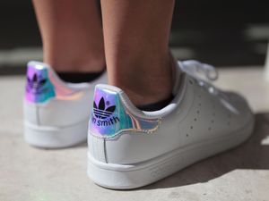 Stan Smith Adidas trainers on feet on ground