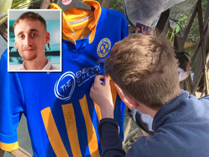 Supporting image for story: Bridge adorned with flowers and Shrewsbury Town gear in tribute to Nathan Fleetwood