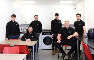 The new canteen area at PTS Group. Directors Mark Bates (L) and Ed Roe (R), seated, with staff behind including director Steve Baldwin (second left)