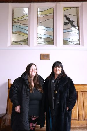 Catherine and Anne Wignall in front of the stained glass window at Ellesmere College in memory of Brendan Wignall.