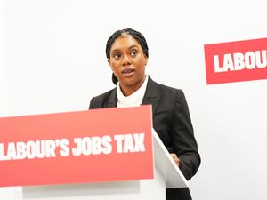 Kemi Badenoch speaks from a lectern with the slogan 'Labour's Jobs Tax'