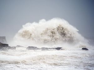 Waves crash over the seafront in Porthcawl in Wales