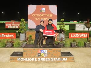 Aero Pattika on the podium with trainer Richie Taberner and greyhound owner Lee Wheeler 